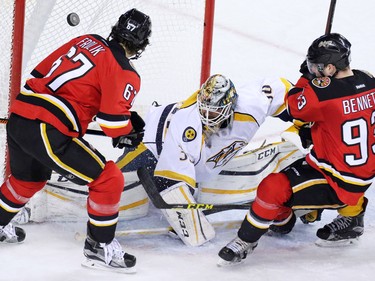 Calgary Flames Michael Frolik and Sam Bennett scramble to score on Nashville Predators goaltender Carter Hutton and tie the game in the closing minutes of the third period of NHL action in Calgary on Wednesday January 27, 2016. Nashville won the game 2-1.