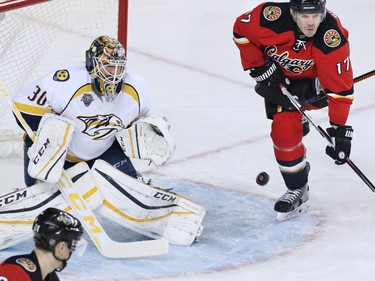 Calgary Flames centre Lance Bouma watches as Nashville Predators  goaltender Carter Hutton stops this scoring chance during the first period of NHL action at the Scotiabank Saddledome on Wednesday January 27, 2016.