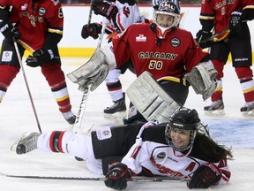 Brampton Thunders player Lindsey Vine slides across Calgary Inferno goalie's Delayne Brian's crease during the Canadian Women's Hockey League in Calgary on March 16, 2014.