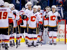 Karri Ramo (31) of the Calgary Flames is congratulated by teammates after defeating the Columbus Blue Jackets 4-2 on Jan. 21, 2016 at Nationwide Arena in Columbus, Ohio.