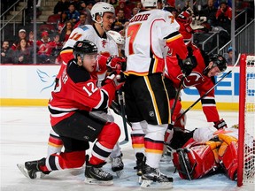 Reid Boucher of the New Jersey Devils celebrates his goal in the second period on Calgary Flames goalie Jonas Hiller.