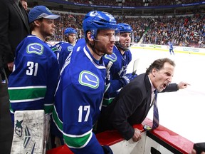 Then-Vancouver Canucks head coach John Tortorella yells at the Calgary Flames' bench during that infamous night of fireworks two years ago. On Thursday, before squaring off against Bob Hartley's Calgary Flames again with his new team — the Columbus Blue Jackets — he talked about learning some lessons.