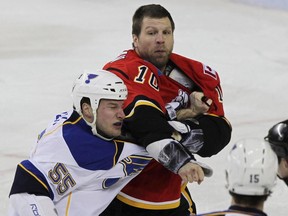 St. Louis Blues Cam Janssen and Brian McGrattan of the Calgary Flames fight during NHL hockey action in Calgary at the Pengrowth Saddledome Monday, January 25, 2010.