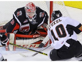 Calgary Hitmen Jakob Stukel is stopped by Moose Jaw Warriors goalie Zach Sawchenko in WHL action at the Scotiabank Saddledome in Calgary, Alberta, on Friday January 22, 2016. The Hitmen lost to the Warriors 5-1. Mike Drew/Calgary Sun/QMI AGENCY