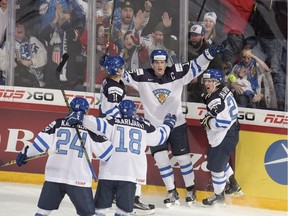 Captain Mikko Rantanen of Finland celebrates scoring with teammates during the 2016 IIHF World Junior Ice Hockey Championship final match between Finland and Russia.