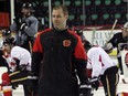 Calgary Flames goalie coach Jordan Sigalet works practice at the Scotiabank Saddledome on Monday. Thursday will mark the 10-year anniversary of his only NHL appearance —  43-second relief stint for the Boston Bruins.