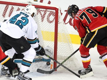 Calgary Flames left winger Micheal Ferland tried to poke the puck past San Jose Sharks goalie Martin Jones in the final seconds of the third period in NHL action at the Scotiabank Saddledome on January 11, 2016. The Sharks defeated the Flames 5-4.