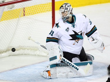 San Jose Sharks goalie Martin Jones looked behind him as a shot by Calgary Flames defenceman Dennis Wideman flew into the net during second period NHL action at the Scotiabank Saddledome on January 11, 2016.