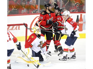 Calgary Flames centre Sam Bennett, second from right, celebrated with teammate defenceman Deryk Engelland after scoring his third goal of the game on Florida Panthers goalie Roberto Luongo during first period  NHL action at the Scotiabank Saddledome on January 13, 2016.