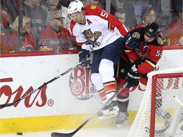Calgary Flames left winger Brandon Bollig applied pressure to Florida Panthers defenceman Brian Campbell during first period  NHL action at the Scotiabank Saddledome on January 13, 2016.