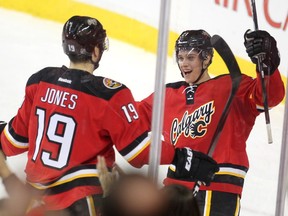 Calgary Flames left winger Mason Raymond, right, celebrated with right winger David Jones after Raymond scored the Flames fifth goal of the game against the Florida Panthers during second period NHL action at the Scotiabank Saddledome on January 13, 2016.