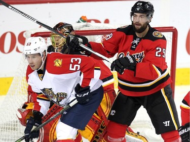 Calgary Flames defenceman Deryk Engelland pushed back against Florida Panthers centre Corban Knight during second period NHL action at the Scotiabank Saddledome on January 13, 2016.