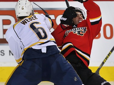 Calgary Flames Johnny Gaudreau collides with Shea Weber of the Nashville Predators during NHL hockey in Calgary, Alta., on Wednesday, January 27, 2016.