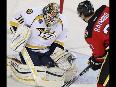 Nashville Predators Carter Hutton with a save against Mason Raymond of the Calgary Flames during NHL hockey in Calgary, Alta., on Wednesday, January 27, 2016.