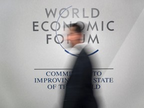 A participant walks past a logo during the World Economic Forumannual meeting in Davos, on Jan. 20, 2016.