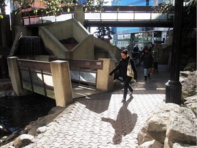 File photo. Pedestrians walk under one of the concrete bridges in Century Gardens at 8th Street and 8th Avenue SW Thursday October 2, 2014. The controversial inner city park with its brutalist architecture  will be undergoing a refurbishing.