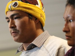 Elijah Provost and his wife, Alexandra Catface, speak with reporters after listening to a speech by Dwight Dorey, National Chief of the Congress of Aboriginal Peoples, at the Central Library in Calgary on Sunday, Jan. 10, 2015. The couple and their three children moved from the Piikani Nation reserve to find work and a new home in Calgary.