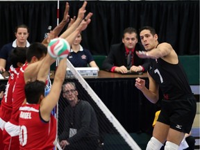 Canada's Dallas Soonias spikes the ball past Team Mexico during during Norcece Men's Continental Olympic Qualification at the Saville Centre in Edmonton, Alberta on January 8 , 2016.