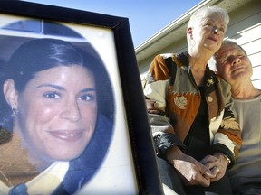 Emile Therien and his wife Beth are pictured with a photo of their daughter Sarah Beth.