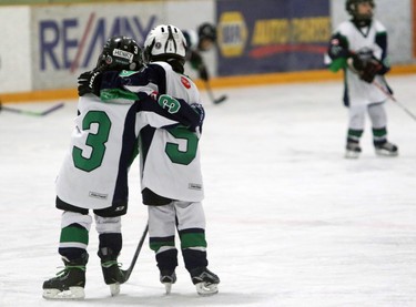 Goalie Philip Kowalewski and Joshua Guiltier with the Springbank Rockies N7 Blue are proud with a 4-1 lead over the Crowfoot Sharks Novice 7 during a Novice North Esso Minor Hockey Week at Shouldice Arena, on January 16, 2016. (Christina Ryan/Calgary Herald)