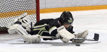 Goalie Hazoor Chana with the Cobras Crowfoot Novice 6 stops the puck during a Novice North Esso Minor Hockey Week at Shouldice Arena, on January 16, 2016. (Christina Ryan/Calgary Herald)