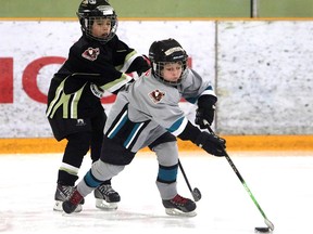 Owen Gallant with the Simons Valley Storm SV Novice 5 out skates a player from the Cobras Crowfoot Novice 6 during a Novice North Esso Minor Hockey Week at Shouldice Arena on Jan. 16, 2016.