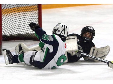 Joshua Guiltier, Springbank Rockies N7 Blue, makes a goal against Crowfoot Sharks N7 goalie Mason Schaalnas the Springbank Rockies win with a 4-1 lead during a Novice North Esso Minor Hockey Week at Shouldice Arena on Jan. 16, 2016.