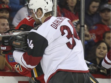 Calgary Arizona Klas Dahlbeck puts Calgary Flames Dougie Hamilton in a headlock during game action at the Scotiabank Saddledome in Calgary, on January 7, 2016.