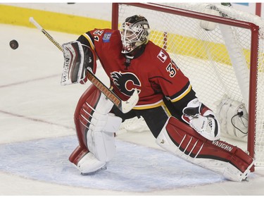Nice blocker save by Calgary Flames Karri Ramo during game action against the Arizona Coyotes at the Scotiabank Saddledome in Calgary, on January 7, 2016.