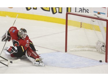 Calgary Flames goalie Karri Ramo can't keep this one out during game action against the Arizona Coytoes at the Scotiabank Saddledome in Calgary, on January 7, 2016.