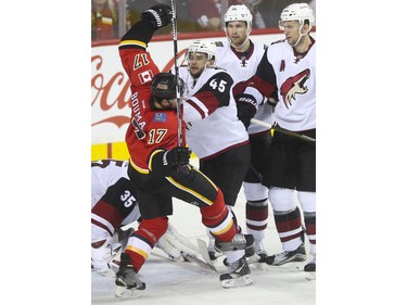 Calgary Flames Lance Bouma gets a shove from Arizona Coyotes Stefan Elliott during game action at the Scotiabank Saddledome in Calgary, on January 7, 2016.