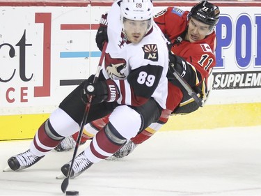 Calgary Flames Mikael Backlund chase down Mikkel Boedker during game action at the Scotiabank Saddledome in Calgary, on January 7, 2016.