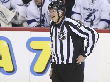 Linesman Mike Cvik laughs between plays during his last NHL career hockey at the Saddledome in Calgary, on January 5, 2016. Cvik retires after tonights match up between the Calgary Flames and the Tampa Bay Lightning.