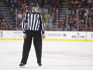 Linesman Mike Cvik watches a play during his last NHL career hockey at the Saddledome in Calgary, on January 5, 2016. Cvik retires after tonights match up between the Calgary Flames and the Tampa Bay Lightning.