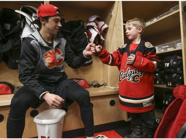 The Calgary Flames Johnny Gaudreau fist bumps Haylen Astalos, 6, after buying a hot chocolate from after practice at the Saddedome in Calgary, on January 17, 2016. Haylen has been selling ice cream or hot chocolate (depending on weather), at his homemade stand, raising money for sick kids at the Ronald McDonald House. He has to date raise over $5000.