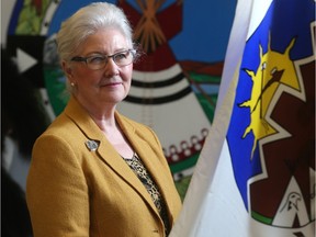 Valerie Hoey, pictured in front of a piece by Siksika artist Richard Emery Duck Chief and a Treaty Seven flag in the school's Aboriginal Centre, was honoured in a Blackfoot ceremony for her work at Bow Valley College.