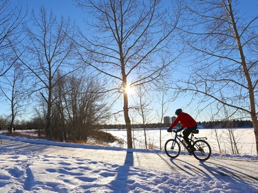 Calgarians enjoy a spectacular New Year's Day along the pathway above Glenmore Lake.