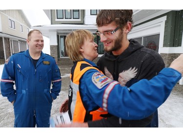 With STARS pilot Greg Chorney smiling STARS flight nurse Pat Jeffery hugs patient Andre Van Driesten after the two realized she had been the flight nurse on the STARS mission that had helped save Andre's life. Andre's heart stopped in 2013 while he was driving near Fort Macleod. Both Andre and Pat were part of the launch for the 2016 STARS lottery.