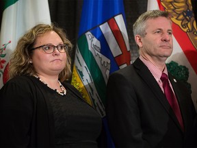 Alberta Health Minister Sarah Hoffman, left, and Prince Edward Island Health Minister Robert Henderson stand together during a news conference after the first day of a meeting of provincial and territorial health ministers in Vancouver, B.C., on Wednesday, Jan. 20, 2016. Federal Health Minister Jane Philpott is scheduled to attend the conference Thursday.