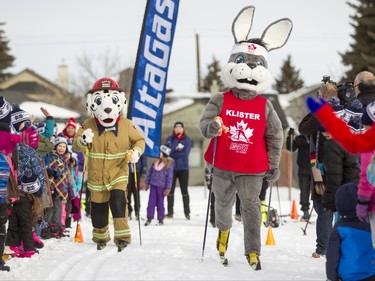 Calgary Fire Department mascot Sparky skis against Klister, the Cross Country Ski de Fond Canada mascot, at Mount View School in Calgary, Alta., on Tuesday, Jan. 26, 2016. The Calgary Fire Department and Calgary Police Service, along with a pair of Olympians, went head-to-head in a relay race for an announcement by AltaGas to support Cross Country Ski de Fond Canada's Ski at School program for the next three years. Lyle Aspinall/Postmedia Network