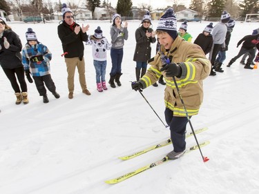 Carol Henke, public information officer with the Calgary Fire Department, pushes through a cross-country skiing race at Mount View School in Calgary, Alta., on Tuesday, Jan. 26, 2016. The Calgary Fire Department and Calgary Police Service, along with a pair of Olympians, went head-to-head in a relay race for an announcement by AltaGas to support Cross Country Ski de Fond Canada's Ski at School program for the next three years. Lyle Aspinall/Postmedia Network