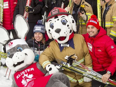 Calgary Fire Department mascot Sparky and Klister, the Cross Country Ski de Fond Canada mascot, sit for a photo with Olympians Sara Renner and Jesse Cockney at Mount View School in Calgary, Alta., on Tuesday, Jan. 26, 2016. The Calgary Fire Department and Calgary Police Service, along with a pair of Olympians, went head-to-head in a relay race for an announcement by AltaGas to support Cross Country Ski de Fond Canada's Ski at School program for the next three years. Lyle Aspinall/Postmedia Network