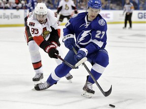 Tampa Bay Lightning winger Jonathan Drouin  battles Ottawa Senators centre Mika Zibanejad during a game last month. Drouin has been sent to the minors and his agent has since revealed he requested a trade in November.