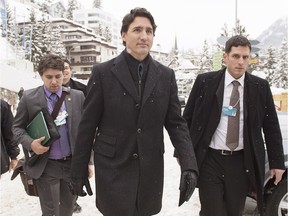 Prime Minister Justin Trudeau , accompanied by staff members, walks through town as he heads to a bilateral meeting in Davos, Switzerland on Wednesday.