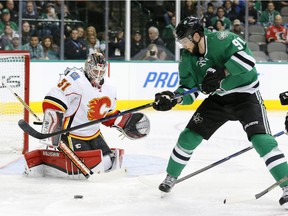 Calgary Flames' goalie Karri Ramo guards the net as Dallas Stars' centre Tyler Seguin tries to corral the puck during first period action Monday night in Dallas.