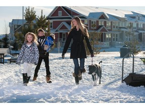 Kimberly Poitras, her two children and their dogs, in Cranston.