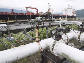 A ship receives its load of oil from the Kinder Morgan Trans Mountain Expansion Project's Westridge loading dock in Burnaby, British Columbia, on June 4, 2015.