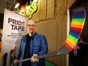 Kristopher Wells of the University of Alberta Institute of Sexual Minority Studies and Services holds a Pride taped hockey stick at Claire Drake Arena n Edmonton, Alberta on Dec. 17, 2015. Pride Tape was announced as a badge of support from the hockey world to the LGBTQ youth.