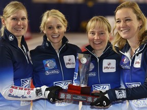 Laine Peters, Jocelyn Peterman, Amy Nixon, and skip Chelsea Carey pose with their trophy after defeating the Val Sweeting rink at  the 2016 Jiffy Lube Alberta Scotties Tournament Of Hearts at North Hill Curling Club on Sunday.