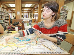 Laura Osburn plays Ticket to Ride during Games Day at the Stratford Public Library on Saturday January 9, 2016. Ticket to Ride is one of the many board games you can play at the newly opened PIPS Board Game Café in Marda Loop.